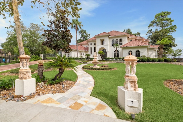 mediterranean / spanish house with a front lawn