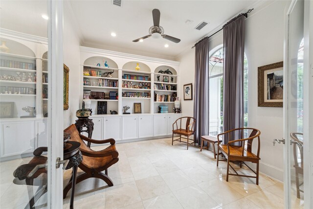 sitting room featuring built in shelves, light tile patterned floors, plenty of natural light, and crown molding