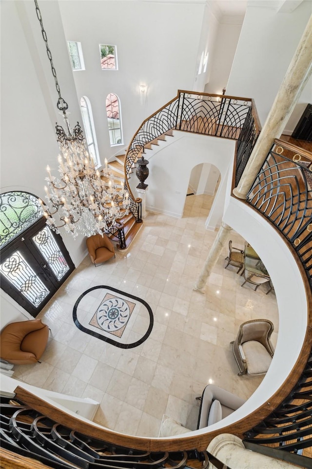 staircase with tile patterned floors and a towering ceiling