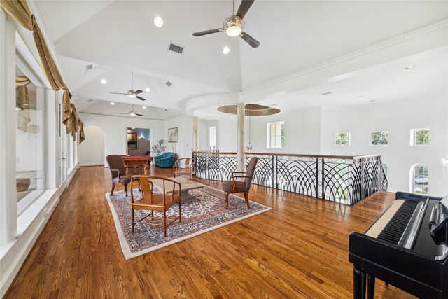 interior space featuring lofted ceiling, crown molding, ceiling fan, and hardwood / wood-style flooring