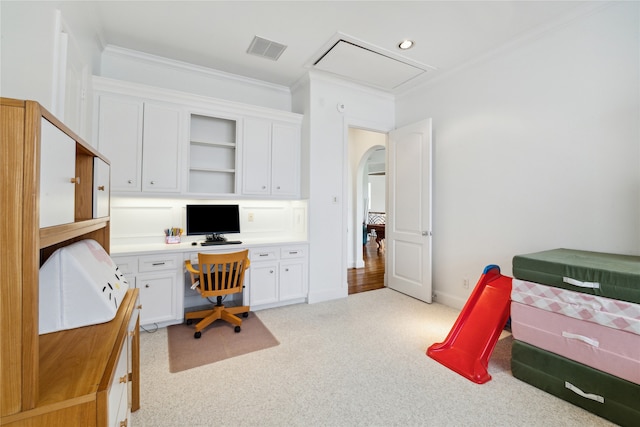 office area with crown molding, light wood-type flooring, and built in desk