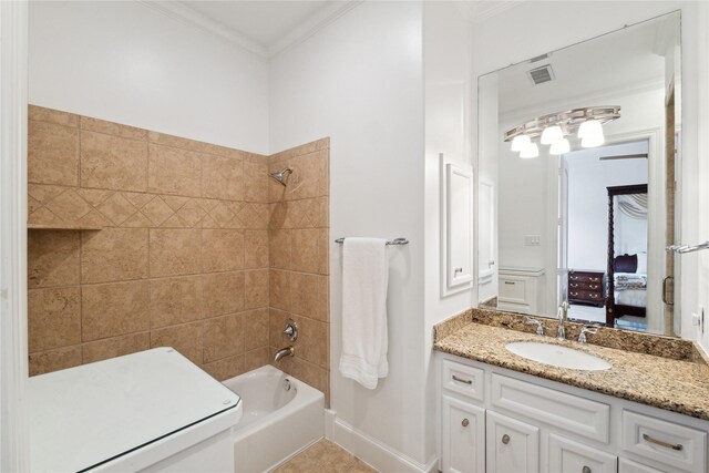 full bathroom with vanity, tile patterned floors, tiled shower / bath, ornamental molding, and toilet