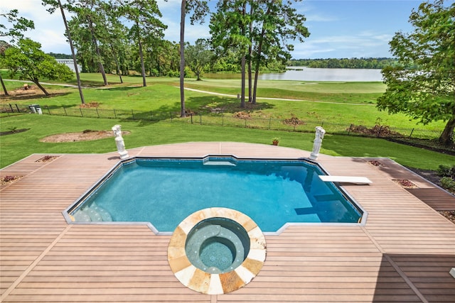 view of pool with a deck, a diving board, and a yard