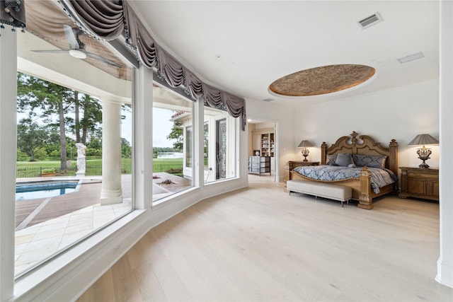 bedroom with crown molding and light hardwood / wood-style flooring