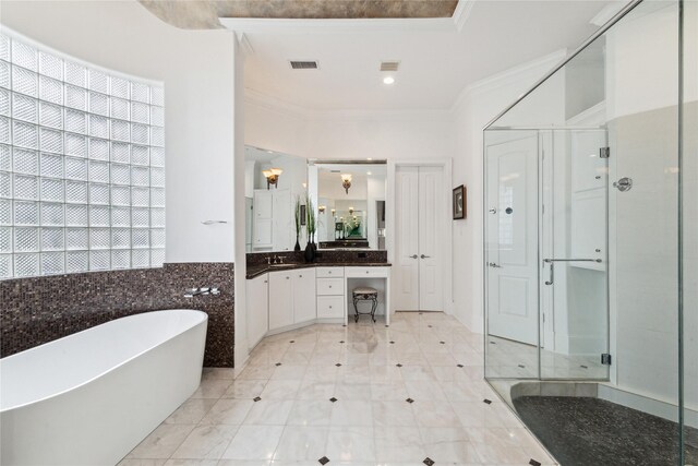 bathroom featuring tile patterned flooring, independent shower and bath, crown molding, and vanity