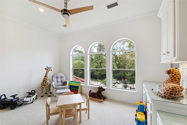 game room with carpet floors, crown molding, and ceiling fan