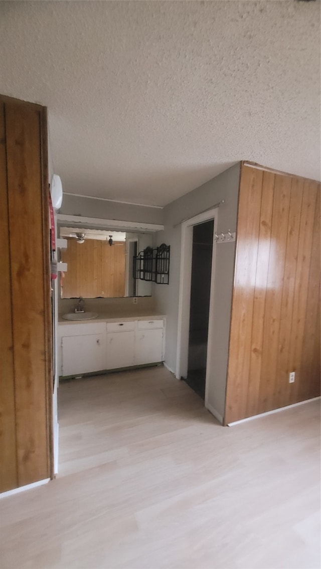 kitchen featuring light hardwood / wood-style floors, sink, and a textured ceiling