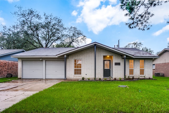 single story home with a garage and a front lawn