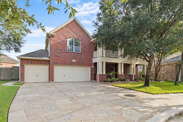 view of front of house with a front yard and a balcony