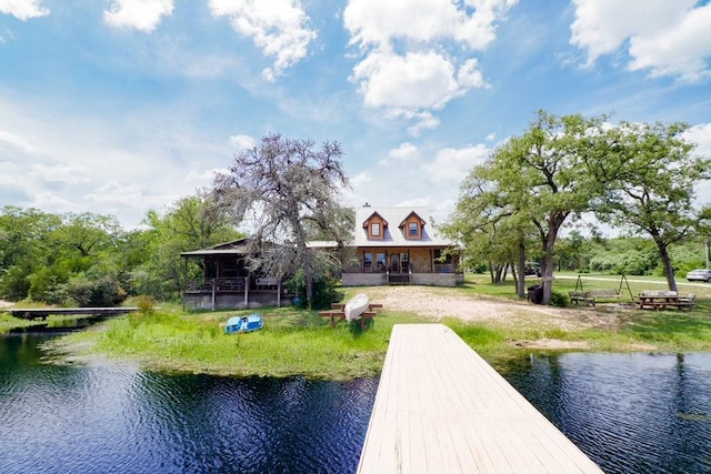 dock area with a yard and a water view