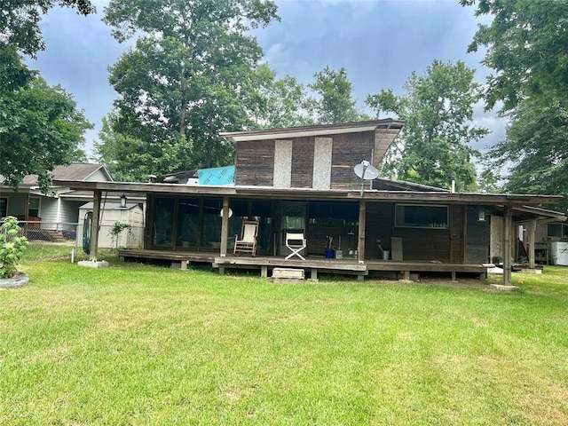 rear view of house featuring a yard