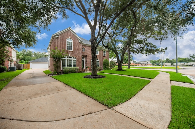 view of front facade featuring a garage, central AC, and a front yard