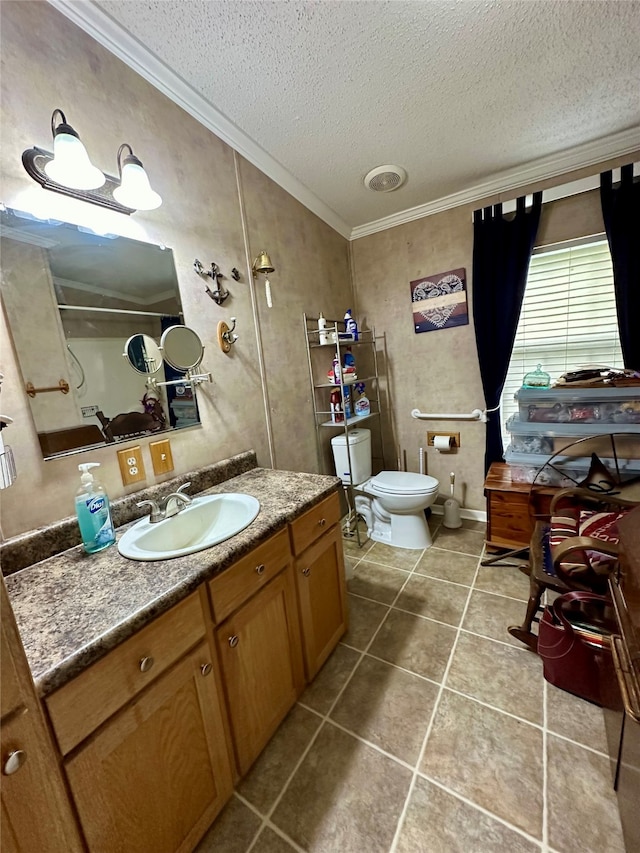 bathroom with a textured ceiling, ornamental molding, vanity, and toilet