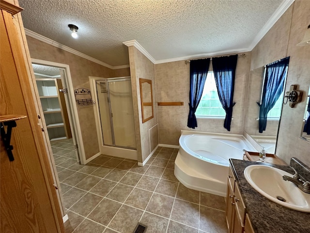 bathroom with vanity, ornamental molding, a textured ceiling, tile patterned floors, and shower with separate bathtub