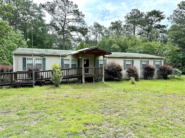 back of house featuring a yard and a wooden deck