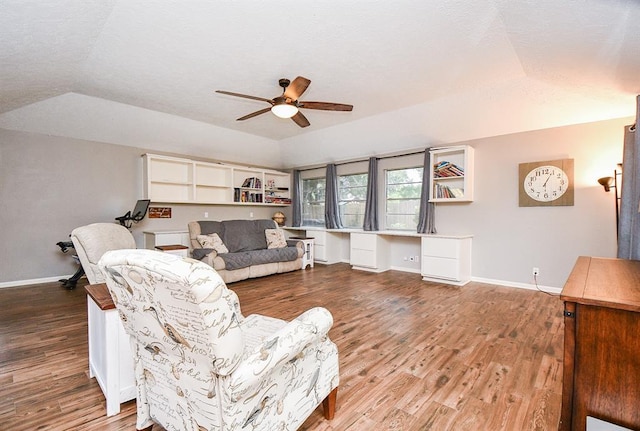 living room with ceiling fan, lofted ceiling, and light hardwood / wood-style floors