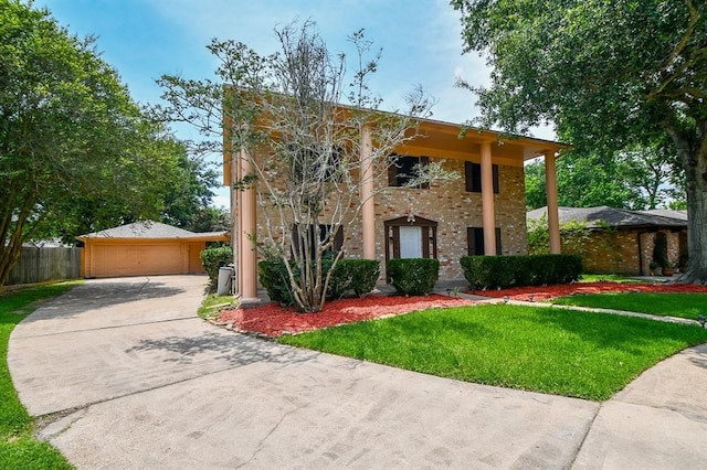 view of front of property featuring a front yard and a garage