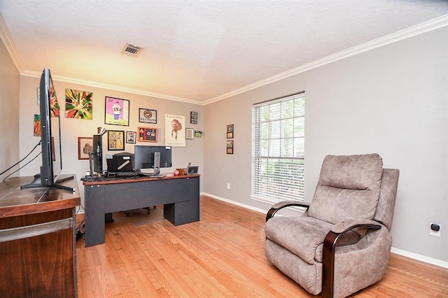 office featuring light hardwood / wood-style flooring, a textured ceiling, and ornamental molding