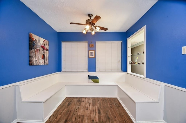 unfurnished dining area with ceiling fan and wood-type flooring