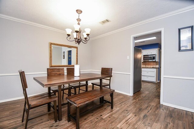 dining area with a notable chandelier, dark wood-type flooring, and crown molding