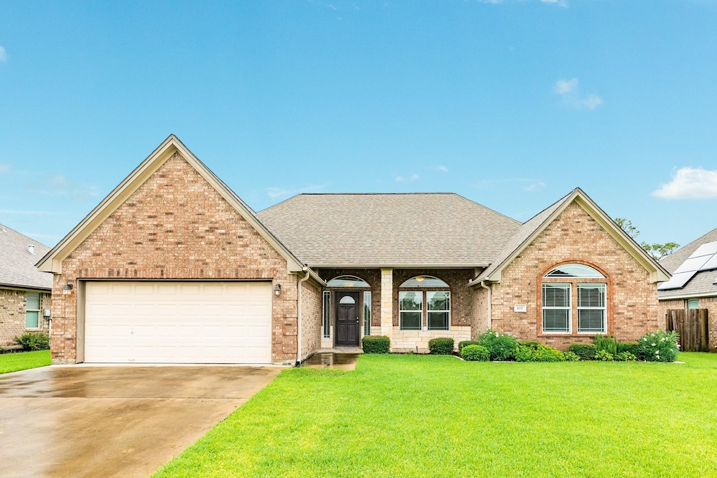 view of front property with a front lawn and a garage