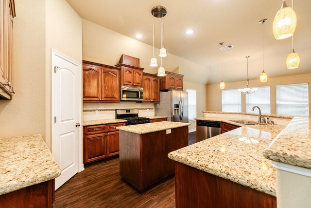 kitchen featuring appliances with stainless steel finishes, tasteful backsplash, sink, pendant lighting, and a large island