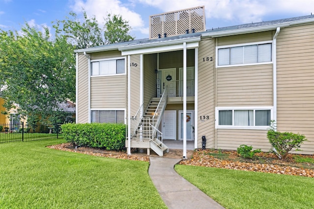 view of property featuring a front yard