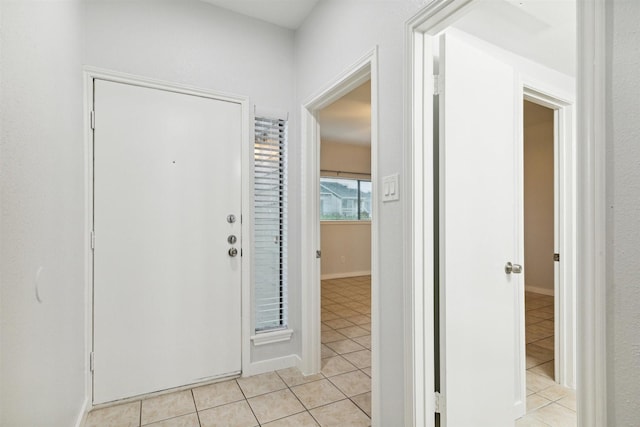 foyer featuring light tile patterned flooring