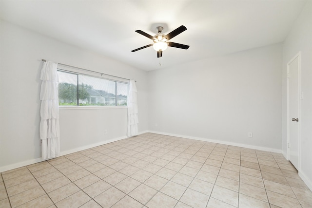 spare room featuring light tile patterned floors and ceiling fan