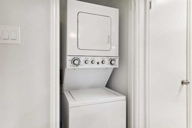 laundry area featuring stacked washing maching and dryer