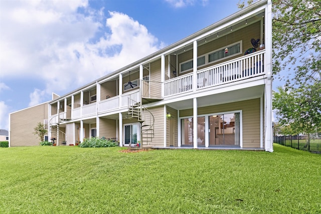 back of property featuring a balcony and a yard