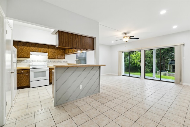 kitchen featuring tasteful backsplash, light tile patterned floors, white range with electric stovetop, ceiling fan, and sink