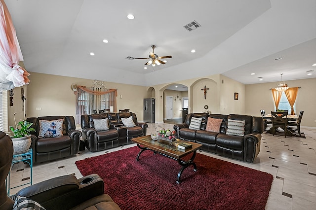 living room featuring ceiling fan with notable chandelier and light tile patterned floors