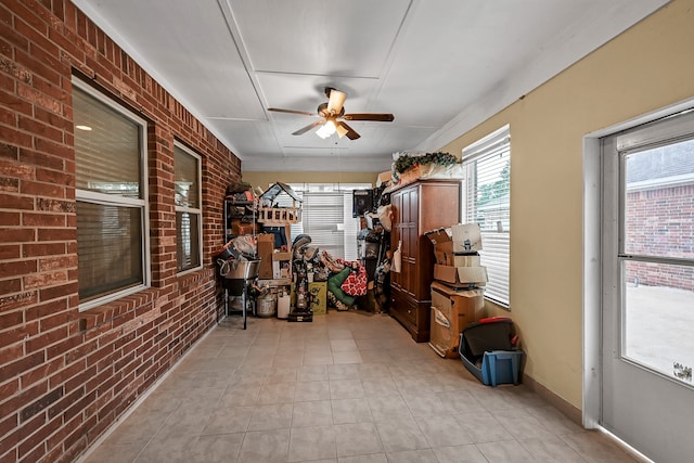 sunroom featuring ceiling fan