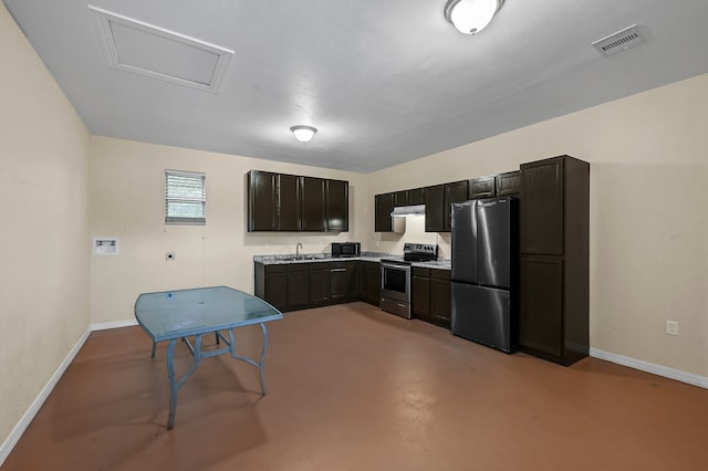 kitchen with electric range oven, stainless steel refrigerator, and sink