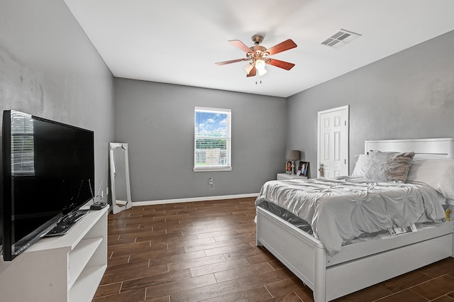 bedroom with dark hardwood / wood-style floors and ceiling fan