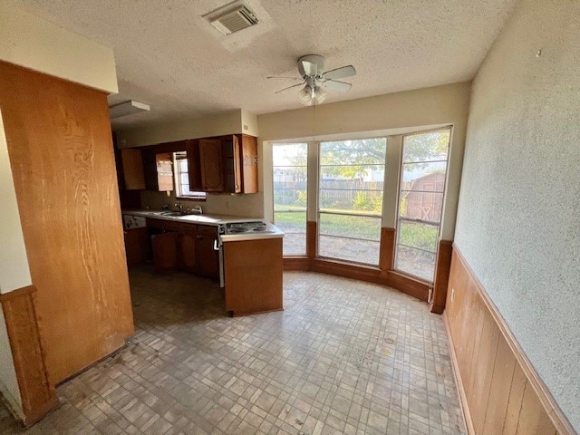 kitchen featuring a textured ceiling, ceiling fan, and sink