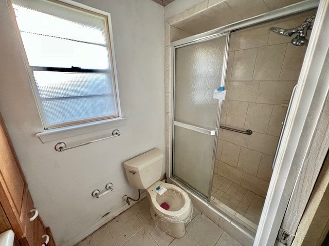 bathroom with walk in shower, tile patterned flooring, and toilet