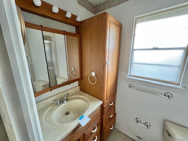 bathroom with an enclosed shower, tile patterned floors, plenty of natural light, and toilet