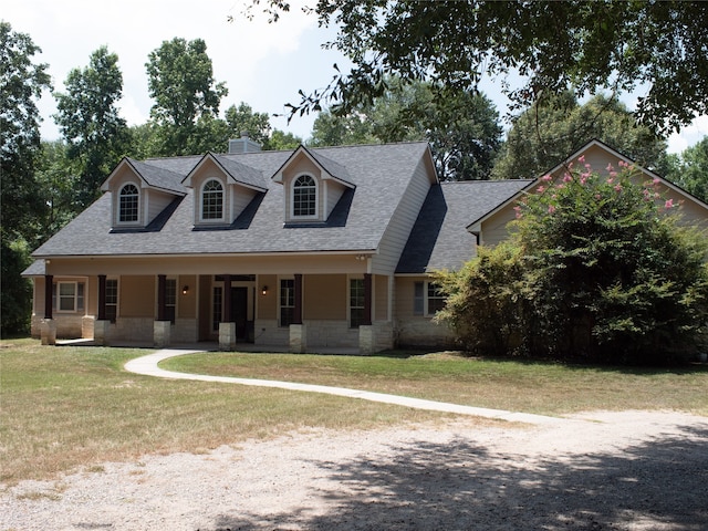 cape cod house featuring a porch and a front lawn