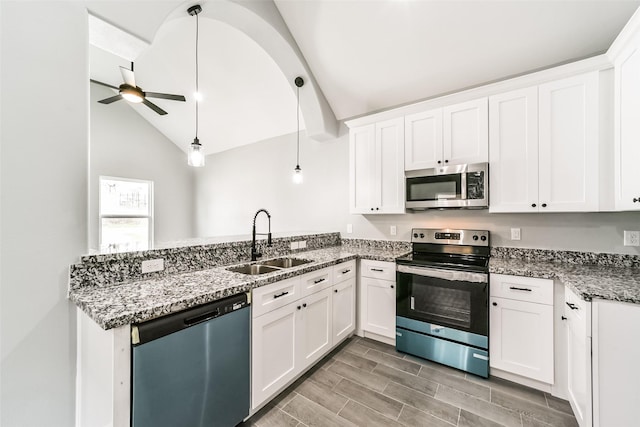 kitchen featuring white cabinetry, appliances with stainless steel finishes, sink, and pendant lighting