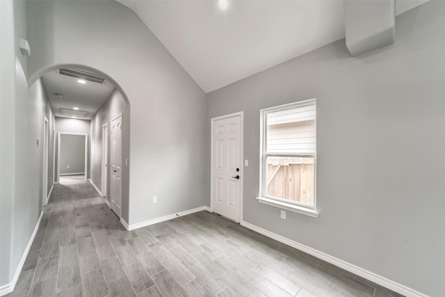 entrance foyer featuring vaulted ceiling and light wood-type flooring