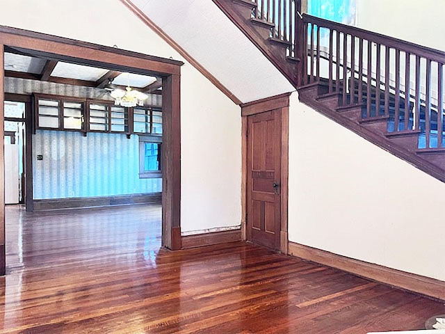 stairs featuring a notable chandelier and hardwood / wood-style floors