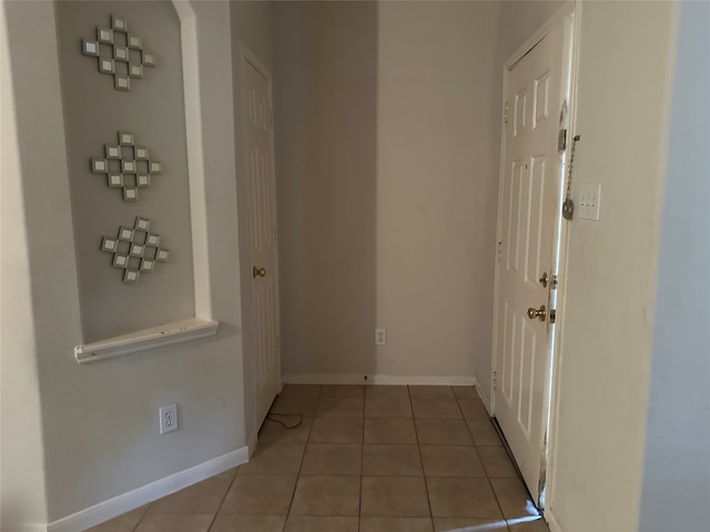 hall featuring light tile patterned floors