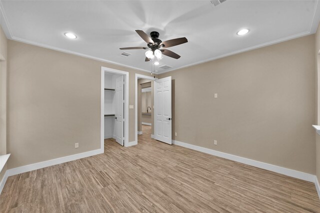 unfurnished bedroom featuring ceiling fan, light hardwood / wood-style floors, and crown molding