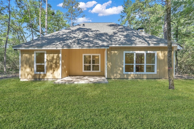 back of house with a patio and a yard