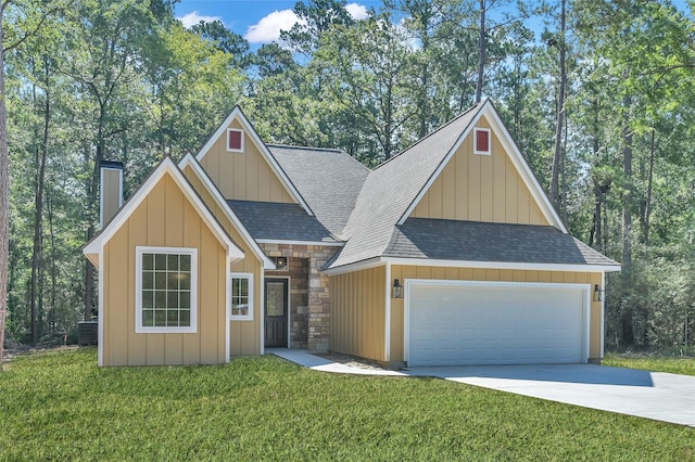 view of front of home featuring a front yard, a garage, and cooling unit