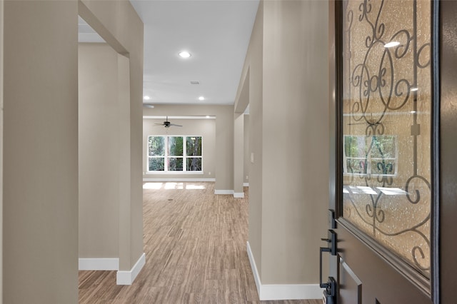 hall with hardwood / wood-style flooring