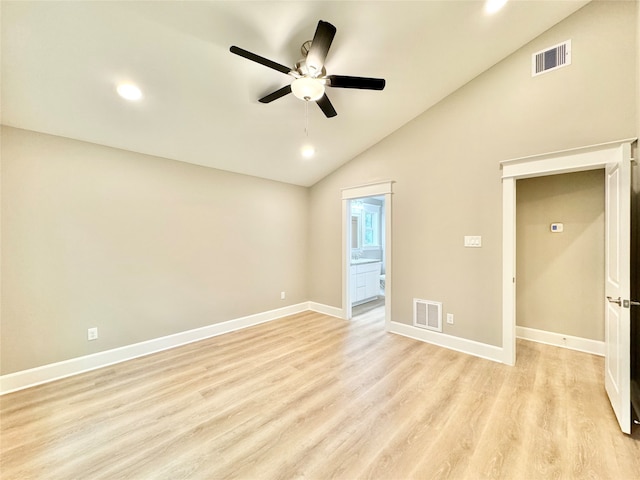 empty room featuring lofted ceiling, light hardwood / wood-style flooring, and ceiling fan