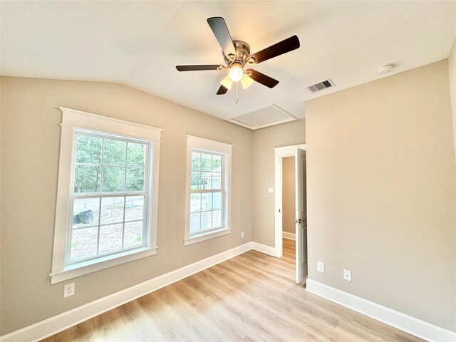 unfurnished room with lofted ceiling, ceiling fan, and light hardwood / wood-style floors